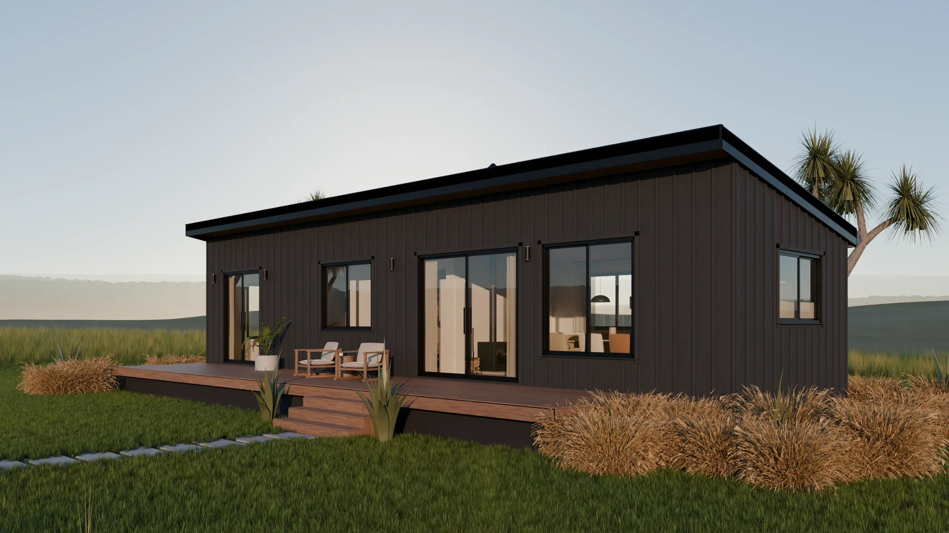 A long black board-and-batten house under one roof rising toward its deck, a timber deck and steps, red tussock and lawn in low evening sun.
